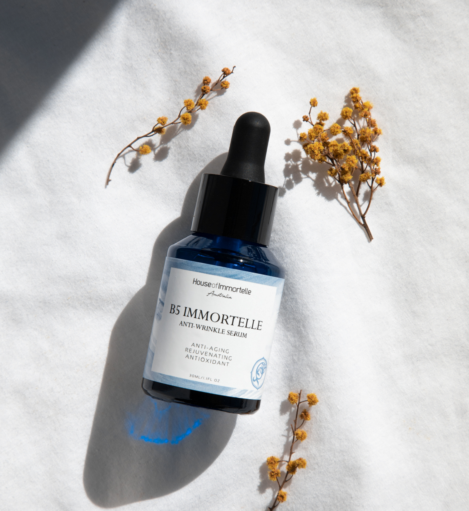 House of Immortelle Anti-Wrinkle Serum bottle with elegant design, featuring a dropper cap. The serum is formulated to reduce fine lines and wrinkles, promoting a youthful and radiant complexion