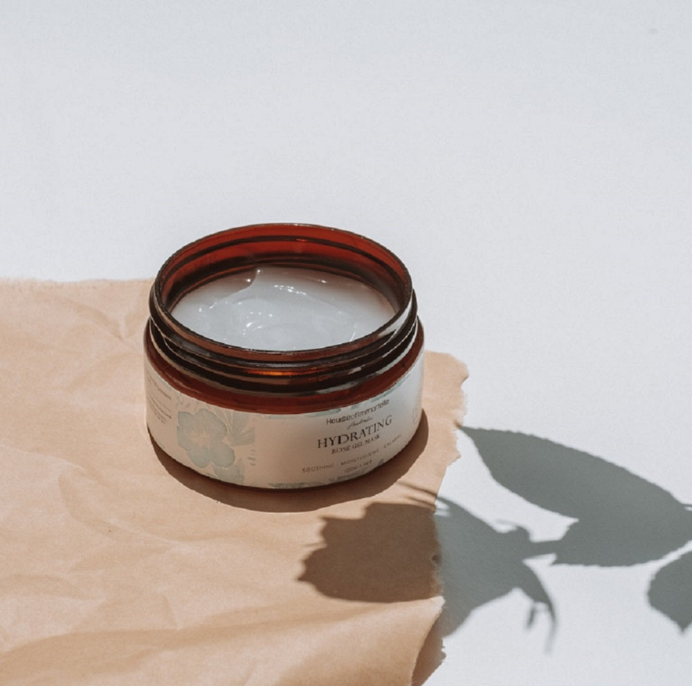 House of Immortelle Bestseller Hydrating Rose Gel Mask in a jar, featuring a refreshing gel formula infused with rose extract. This mask provides intense hydration and nourishment, leaving the skin feeling plump, radiant, and rejuvenated